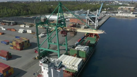 Crane unloading cargo ship at container terminal port, aerial view Stock Footage 130649015