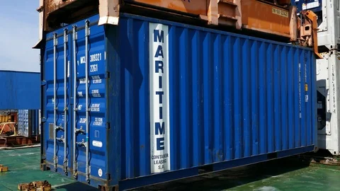 Crane is unloading a container from a ship at daytime 4k intro video busines Stock Footage 104498100