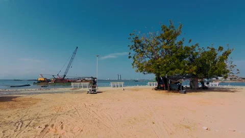 Crane Vessel near Sandy Beach with Green Tree and Coastal City View Stock Footage 337028128