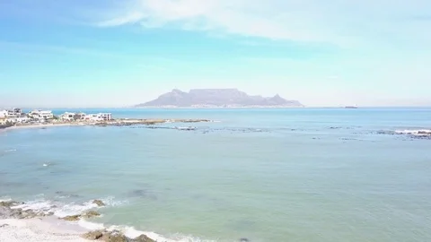 A crane view of Table Mountain from Big bay in 4k Stock Footage 80822630
