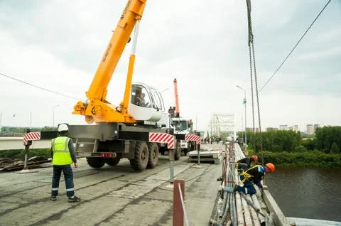 Crane work on bridge reconstruction site Stock Photos