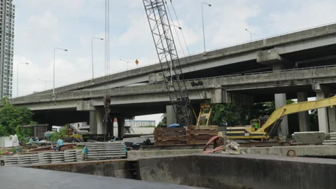 Crane working beneath elevated highway in Bangkok Stock Footage 345861452