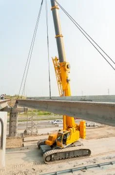 Crane working on bridge construction Stock Photos