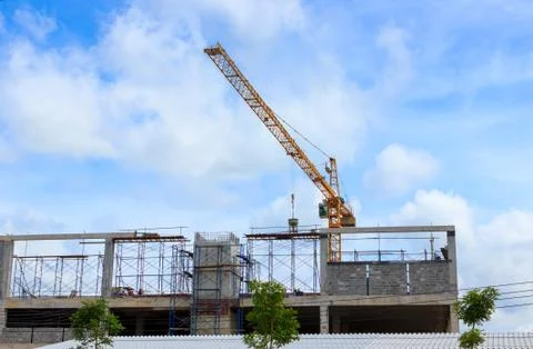 Crane working in construction on blue sky Stock Photos