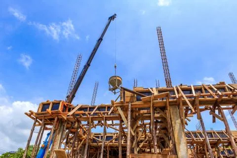 Crane working in construction on blue sky Stock Photos