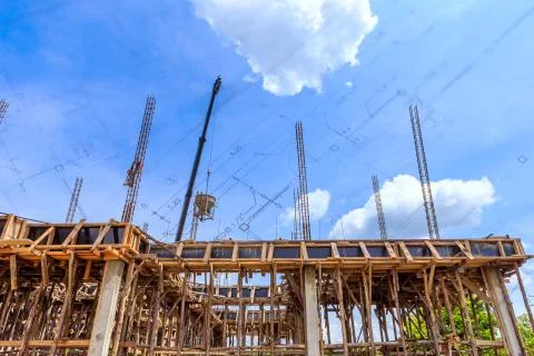 Crane working in construction on blue sky Stock Photos