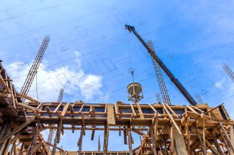 Crane working in construction on blue sky Stock Photos