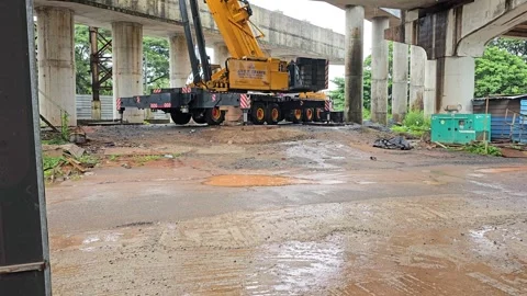A crane working on the construction of a new bridge or flyover. 스톡 동영상 315590392