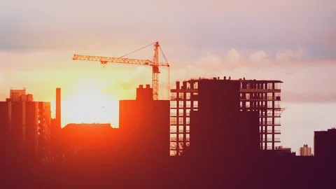 Crane working on construction site building, constructors working at sunrise Stock Footage 103833107