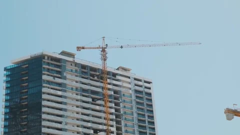 Crane working on construction site. Building skyscrapers, multi storey houses Stock Footage 265892396