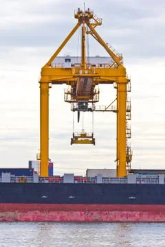 Crane working with container cargo in shipyard Stock Photos
