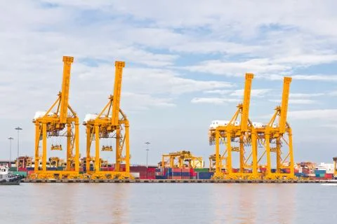 Crane working with container cargo in shipyard Stock Photos