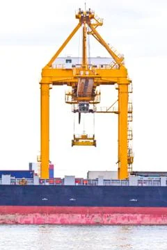 Crane working with container cargo in shipyard Stock Photos