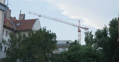 A crane working in the middle of a city Stock Footage 100648013