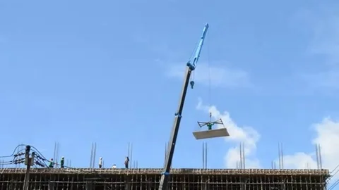 Crane working on tower in construct site and blue sky Stock Footage 98247822