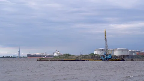 The crane works, pulls bucket out of water from water and spills it elsewhere Stock Footage 127116831