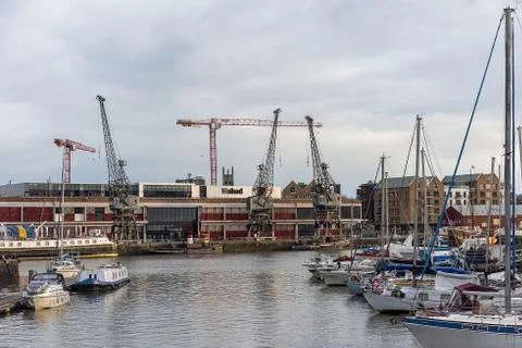 Cranes and construction work going on adjacent to the waterfront Stock Photos