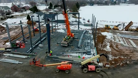 Cranes and construction workers are active at a building site in winter. Heavy Stock Footage 336108849