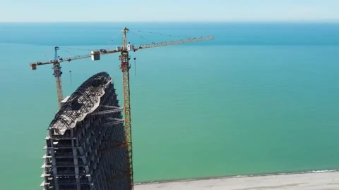 Cranes and seaside skyscraper construction Stock-Footage 168614132