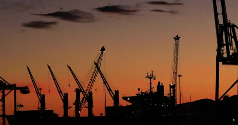 Cranes and ships in the harbor at sunset Stock Footage 261601070