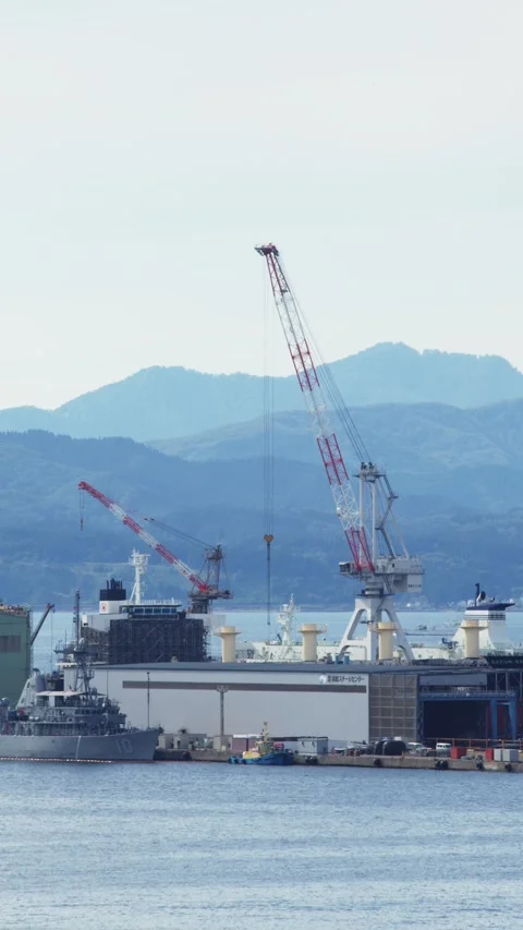 Cranes and shipyard facility over blue water, Hakodate, Japan, 2026.09.10. 動画素材 345440695
