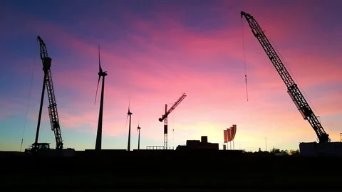 Cranes and windmills at sunset Stock Footage 99438849
