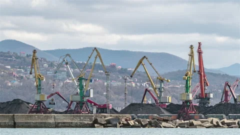 The cranes are loading bulk materials and coal in the seaport. Stock Footage 171855462