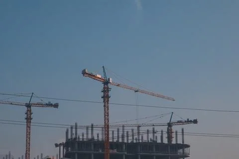 Cranes on the background of the construction site Stock Photos