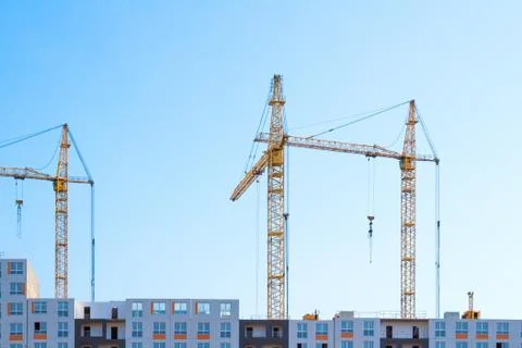 Cranes on blue sky Stock Photos
