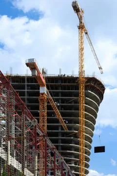 Cranes on building construction site Stock Photos