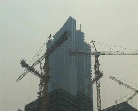 Cranes constructing buildings under pollution Stock Footage 285284