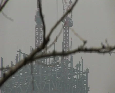 Cranes constructing buildings under pollution Stock Footage 337198