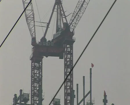 Cranes constructing buildings under pollution Stock Footage 337431