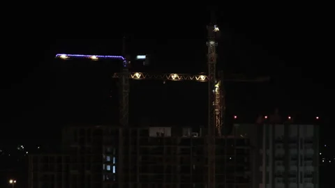 Cranes on construction site at night, timelapse 스톡 동영상 130849002