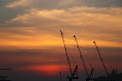 Cranes construction site with silhouette development beautiful  sunset backgr Foto stock