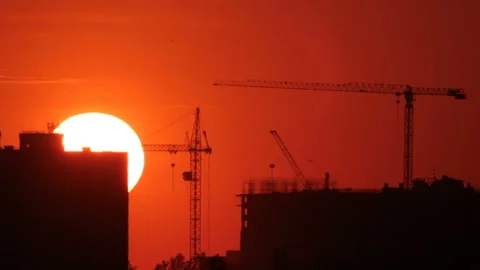 Cranes on construction in sunrise Stock Footage 99622706