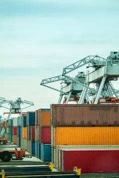 Cranes with containers in a harbor Stock Photos