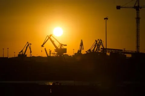Cranes on the docks in the sunset Stock Photos