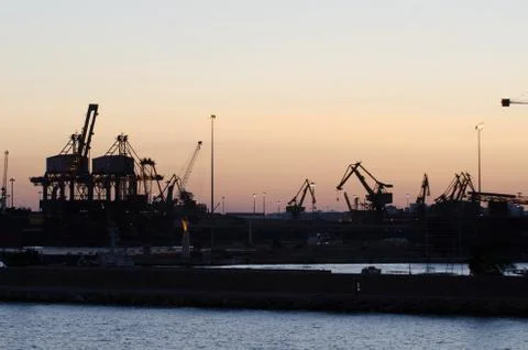 Cranes on the docks in the sunset Stock Photos