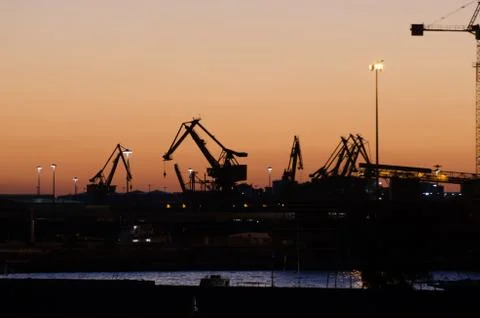 Cranes on the docks in the sunset Stock Photos
