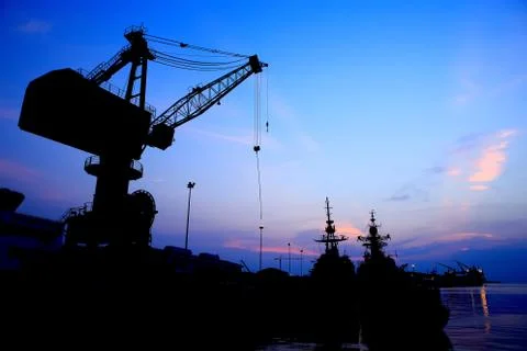 Cranes in dockside at sunset Stock Photos