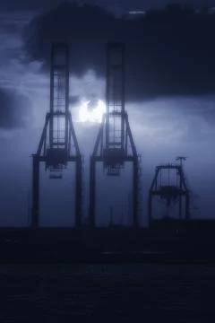 Cranes in harbor at the sunset Stock Photos