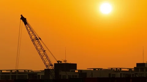 Cranes lifting containers running background sunset in the evening Stock Footage 120744867