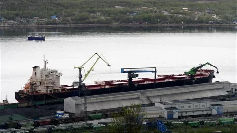 Cranes load a big ship with coal in the Murmansk seaport. Stock Footage 131657572