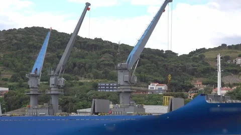 Cranes to load goods in cargo ship at the dock Stock Footage 342796424