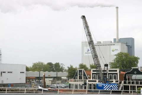 Cranes for loading and unloading of goods. Cocoa refining plant. Stock Photos