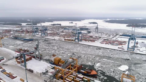 Cranes loading cargo vessels at arctic harbour Video stock 94655728