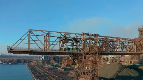 Cranes for loading at an industrial plant standing at sea Stock Footage 99014523
