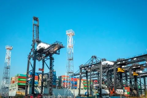 Cranes loading shipping container on freight harbor logistics centre in Hong  Stock Photos