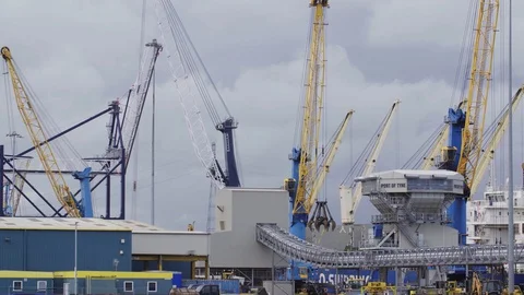 Cranes moving on shipping yard loading containers Stock Footage 127585236
